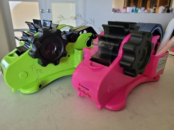 Green and Pink Echomerx Tape Dispenser for automatic tape cutting.